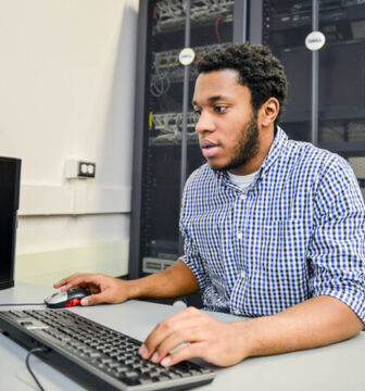 A young man works at a computer
